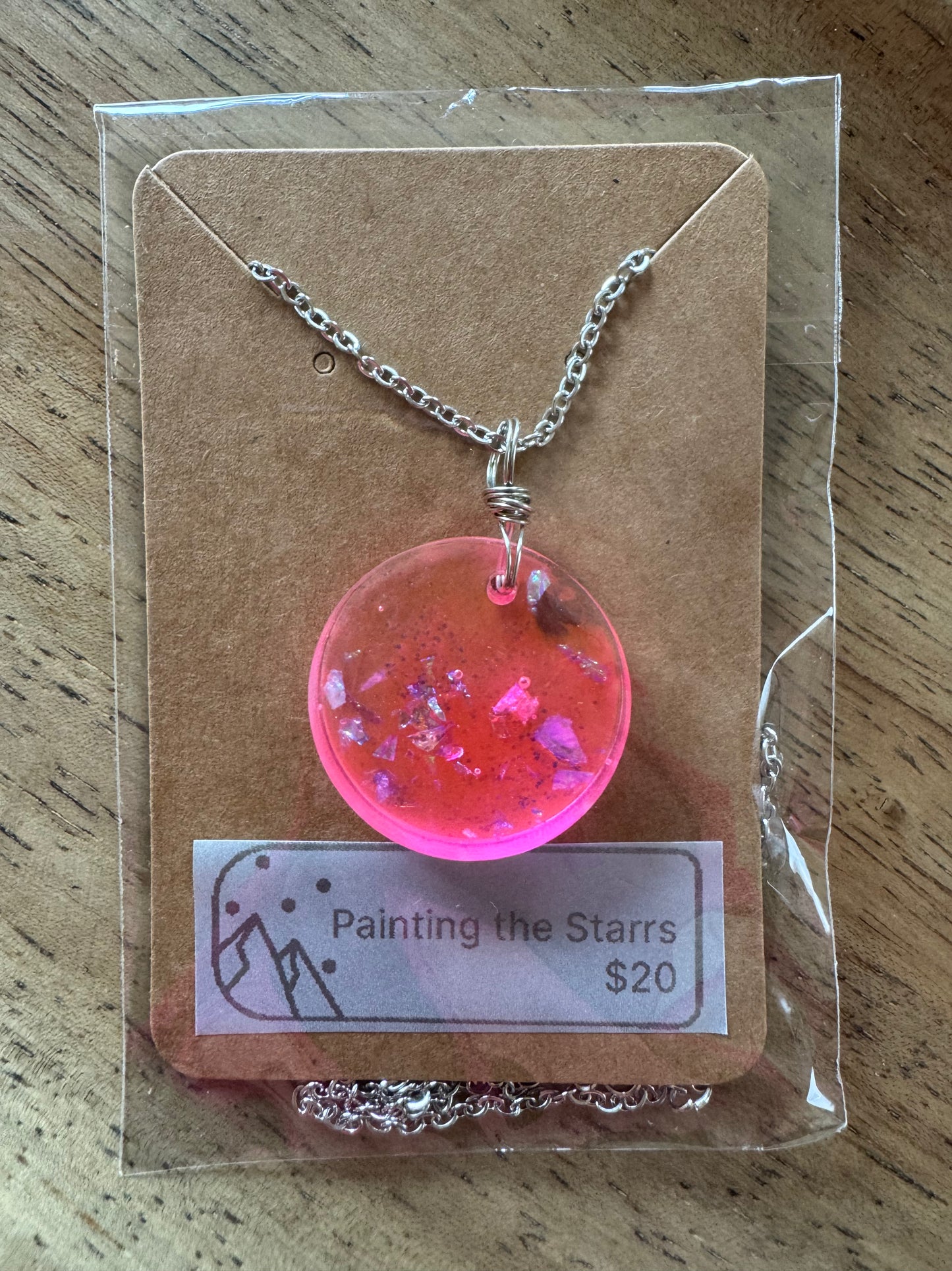 Bright pink resin circle with metal flecks