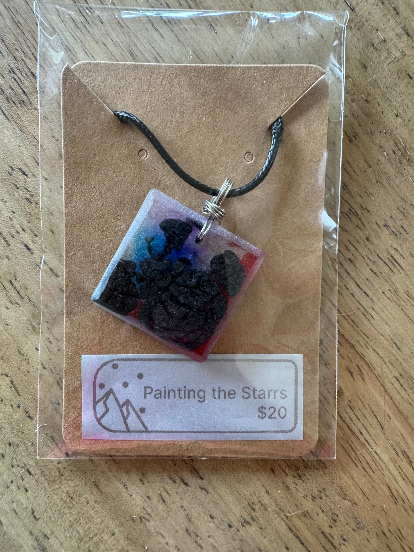 Square resin piece with purple, blue, red and black