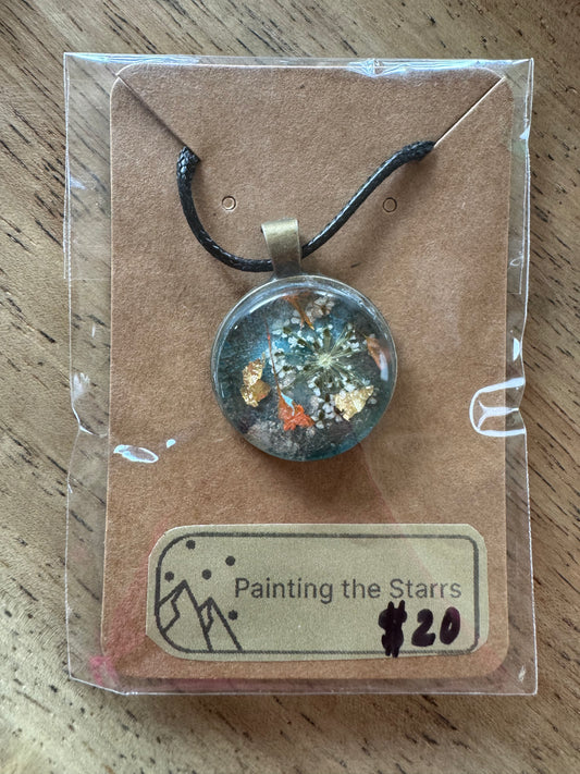 Blue resin with white and orange flowers