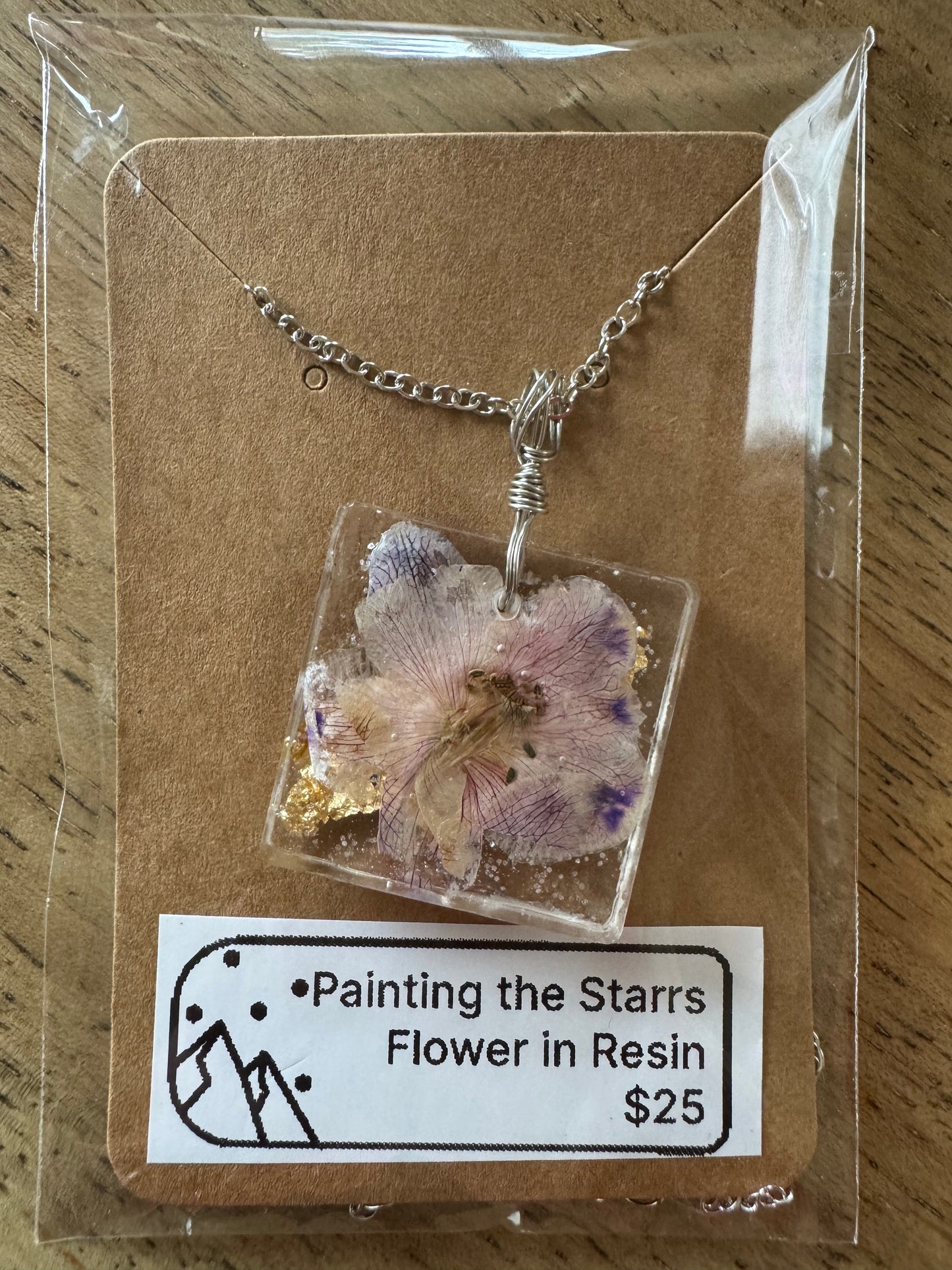 Purple flower in resin with gold flecks