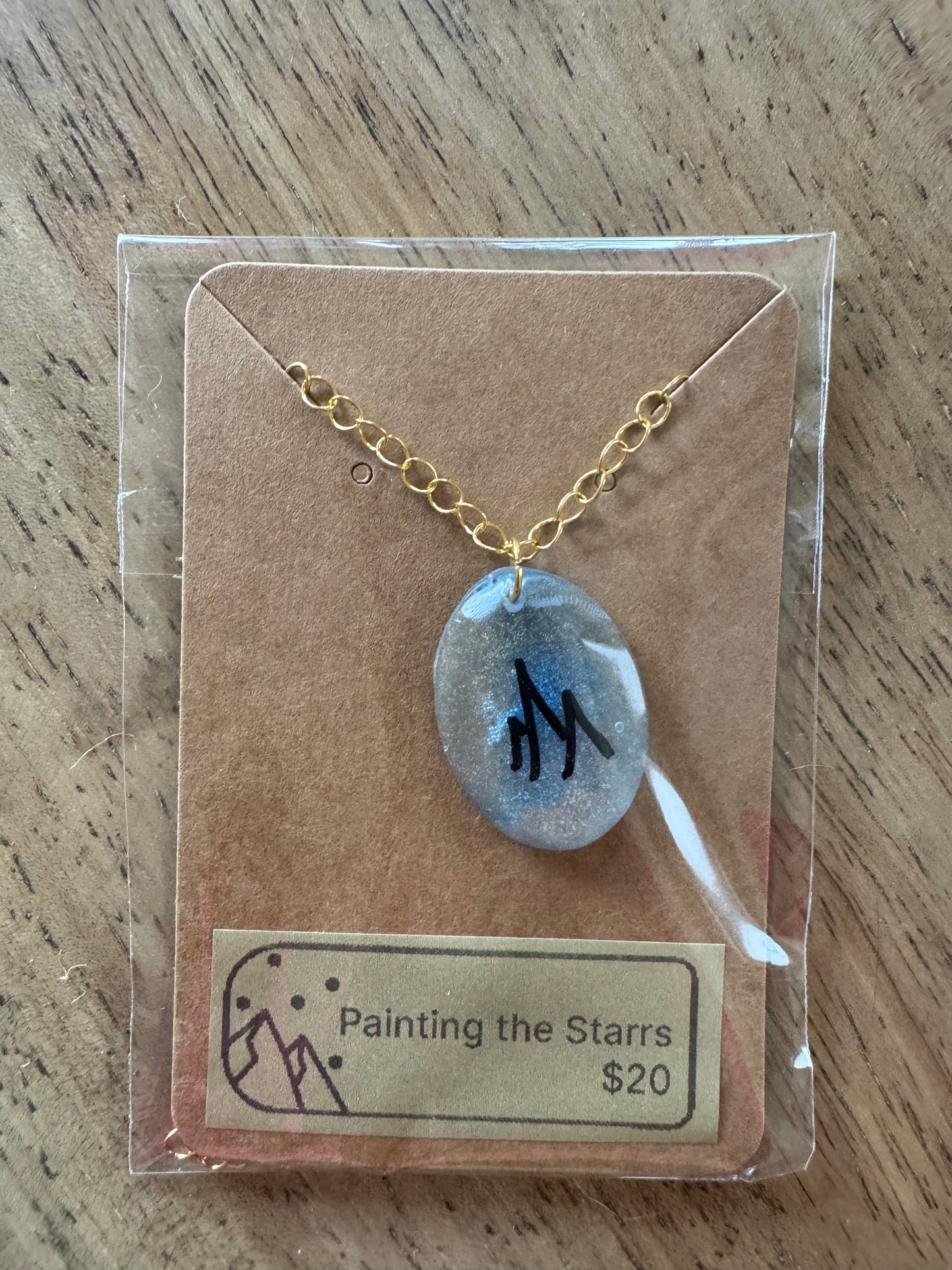 Oval gold and blue mica resin with mountains