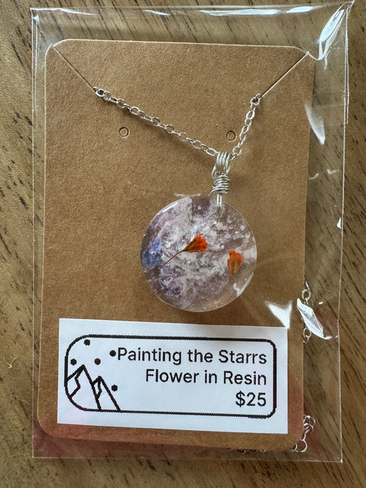 Purple and orange flowers in resin